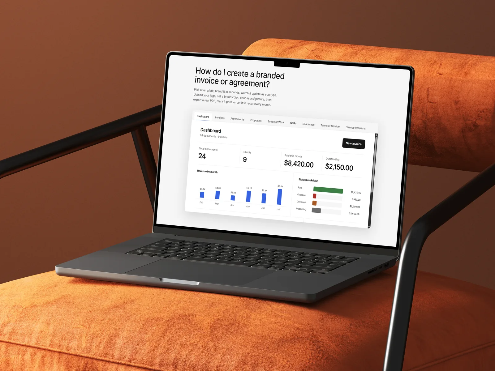 A MacBook on an orange armchair showing the Client Paper Co. client billing dashboard with revenue by month and paid, overdue, and outstanding totals